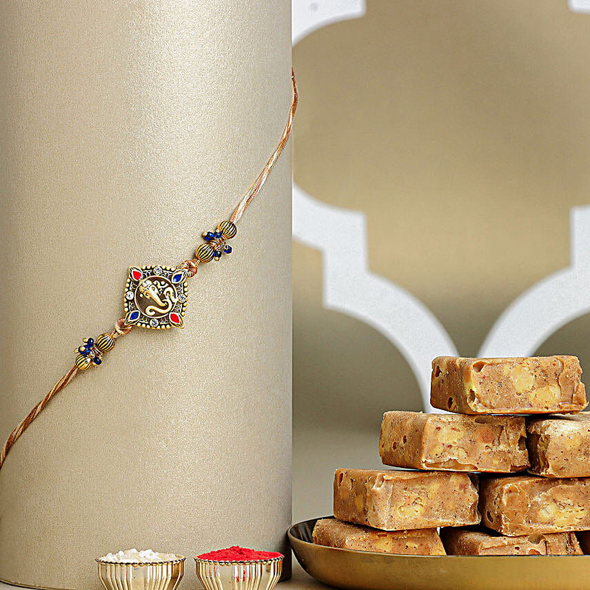 Celestial Ganesha Serenade Rakhi with Channa Barfi Combo