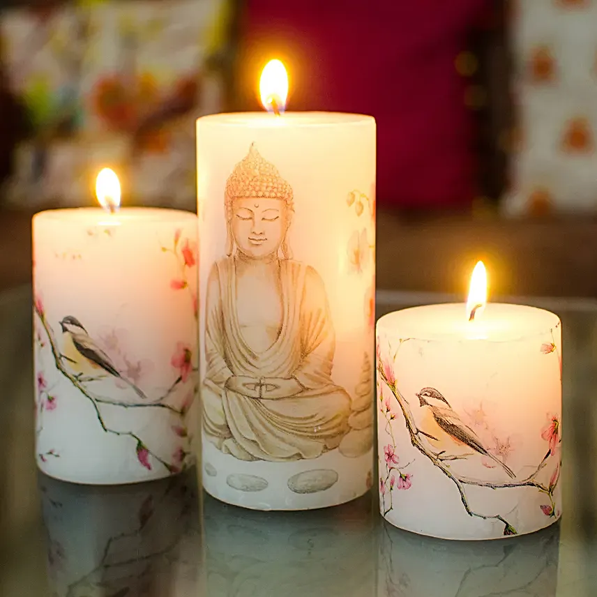 https://www.fnp.com/images/pr/l/v20220316153724/set-of-3-buddha-print-pillar-candles-gift-set_1.jpg
